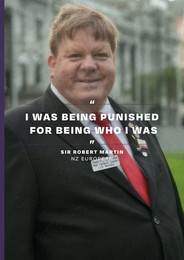 Sir Robert Martin KNZM standing outside Parliament, smiling and wearing a suit with w white shirt and red tie