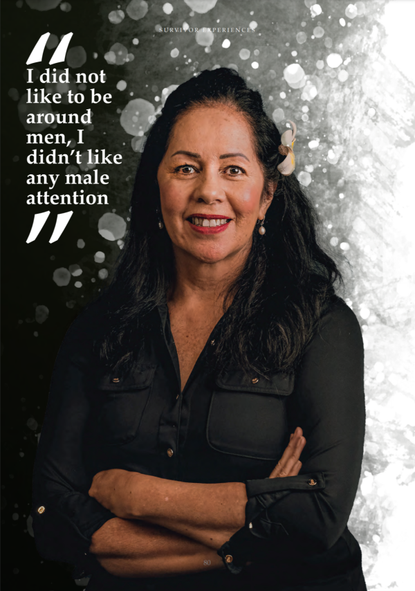 Frances Tagaloa wearing a black shirt and a flower in her hair